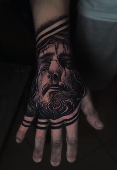 Jesus portrait hand tattoo